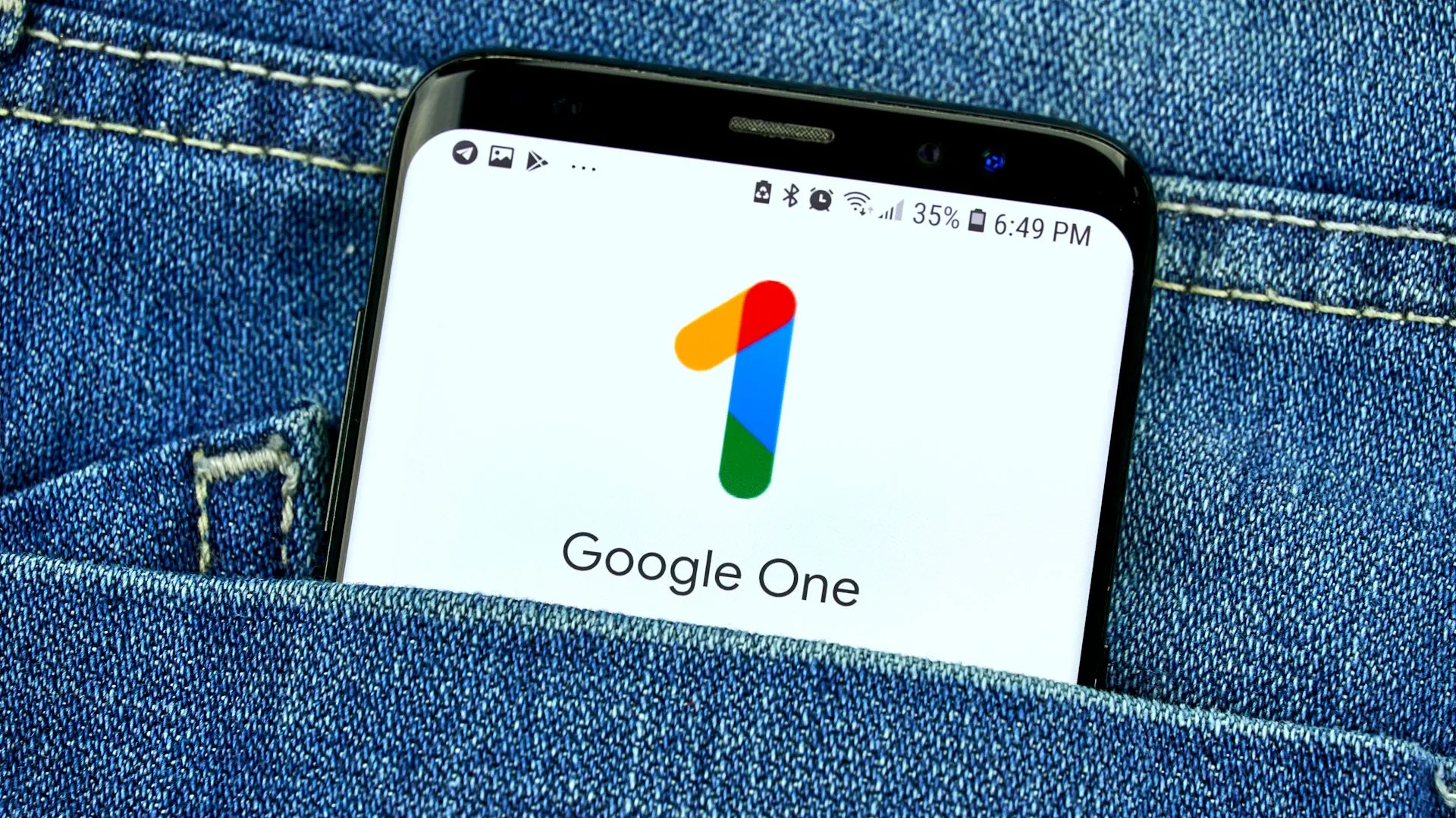 Màn hình ứng dụng Google One hiển thị trên điện thoại trong túi quần jean