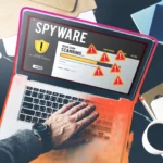 Người dùng đang quét tìm phần mềm gián điệp trên laptop với các dấu hiệu cảnh báo